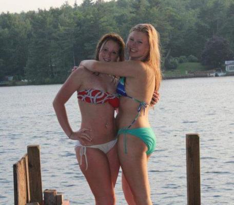 Two teens in bikinis on a pier