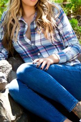 Emma Mae outside takes off her plaid and jeans