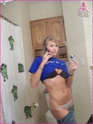 Blonde teen taking bathroom mirror-shots