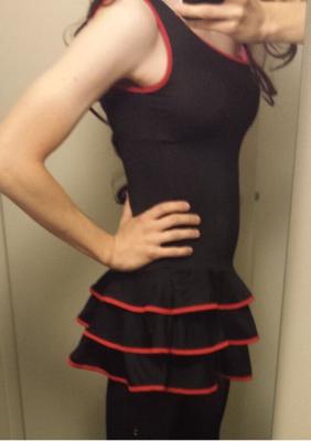 Petite crossdresser maigre en robe noire à volants