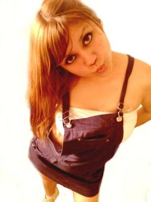 Cute teen posing in overalls bib dress