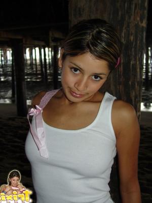 Trixie posing under the pier in white vest