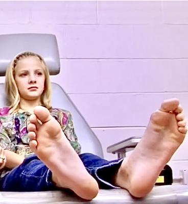 Anxious blond goes to the Dr., and gets her LONG soles exposed